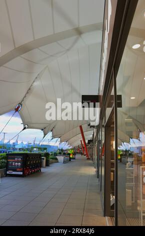 Covered walkway at the Ashford Designer Outlet shopping centre Ashford Kent England UK Stock Photo