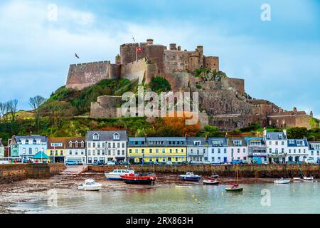 Mount Orgueil castle over the Gorey village promenade with yachts on the shore, Saint Martin, bailiwick of Jersey, Channel Islands, Great Britain Stock Photo