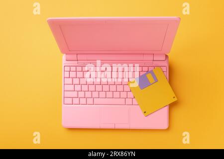 Colored pinColored pink laptop with bright floppy disk, modernity concept.k laptop with bright floppy disk, modernity concept. High quality photo Stock Photo