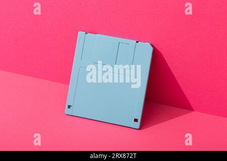 Blue floppy disk on a pink background. High quality photo Stock Photo