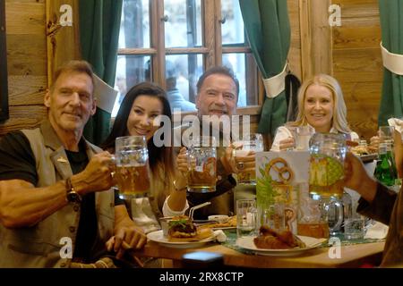 Munich, Germany. 23rd Sep, 2023. The actor Ralf Moeller (l-r), with company, Arnold Schwarzenegger and his girlfriend Heather Milligan celebrate in the Marstall festival tent. The 188th Wiesn takes place this year from 16.09.- 03.10.2023. Credit: Felix Hörhager/dpa/Alamy Live News Stock Photo