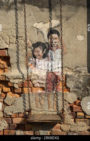 Brother & Sister on a Swing Penang Street Art, Pulau Pinang, Malaysia Stock Photo