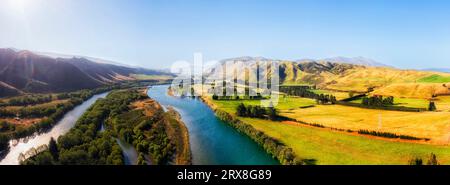 Waitaki river in Otago mountain area of South Island in New zealand at Kurow town - scenic aerial panorama over river course valley. Stock Photo