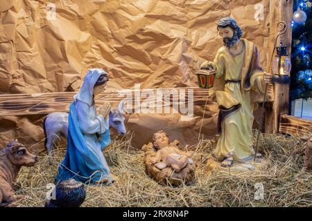 nativity scene with hand-colored figures made out of wood. Stock Photo