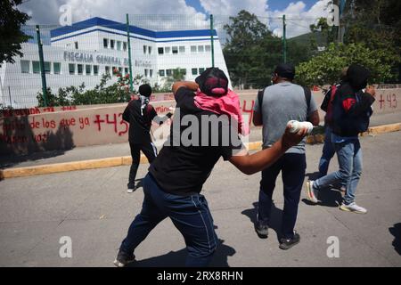 Chilpancingo, Mexico. 23rd Sep, 2023. Students from the Raul Isidro Burgos de Ayotzinapa rural school throw firecrackers at the Attorney General's Office in the state of Guerrero. Corrupt police officers had kidnapped 43 students from the Ayotzinapa Teachers' Seminary in the southern city of Iguala on the night of September 27, 2014, and handed them over to the Guerreros Unidos crime syndicate. The background to the crime has not yet been fully clarified. Credit: Jesús Ramírez/dpa/Alamy Live News Stock Photo