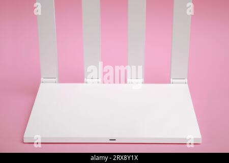 One modern Wi-Fi router on pink background Stock Photo