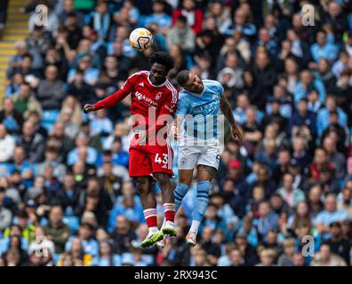Manchester, UK. 24th Sep, 2023. Nottingham Forest's Ola Aina (L) challenges for a header with Manchester City's Kyle Walker during the English Premier League match between Manchester City and Nottingham Forest in Manchester, Britain, on Sept. 23, 2023. Credit: Xinhua/Alamy Live News Stock Photo
