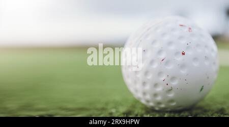 Sports, hockey and ball on astro turf closeup with space for marketing or advertising outdoor. Fitness, exercise or training on grass and equipment on Stock Photo