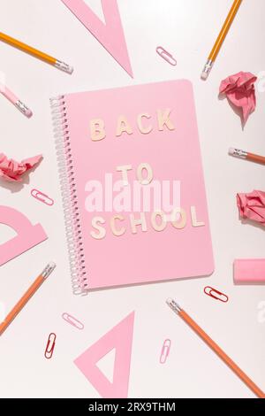 Lettering back to school on a pink background with school supplies. High quality photo Stock Photo