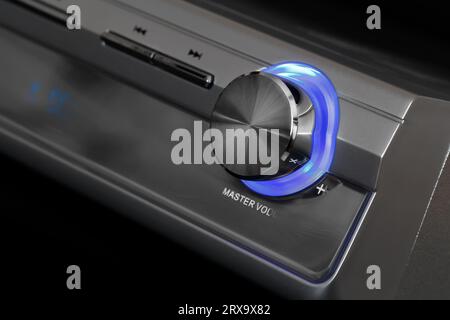 Volume control with blue backlight. Equipment for sound reproduction. Close-up with shallow depth of field Stock Photo