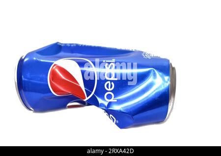 Cairo, Egypt, September 19 2023: Crushed dented Pepsi can, Cola flavor bottle, a carbonated soft drink manufactured by PepsiCo. Originally created, de Stock Photo