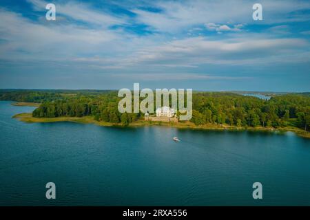 Aerial drone view shot of Uzutrakis Manor in Trakai Galve lake, Lithuania during daylight in autumn Stock Photo