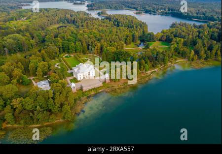 Aerial drone view shot of Uzutrakis Manor in Trakai Galve lake, Lithuania during daylight in autumn Stock Photo