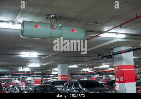 Jet fan at underground parking area. Ventilation fan in the parking lot. Air flow system. Ventilation system in underground car parking lot Stock Photo