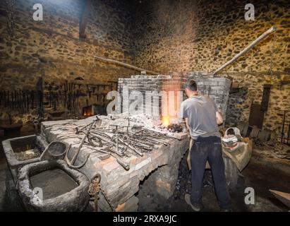 Ferron working in the forge of the El Pobal ironworks Stock Photo