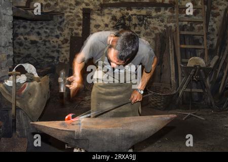 Ferron working in the forge of the El Pobal ironworks Stock Photo