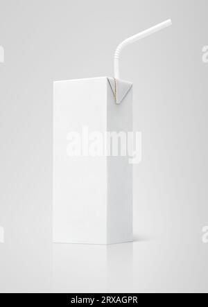 200 ml milk or juice white carton package with straw on gray background Stock Photo