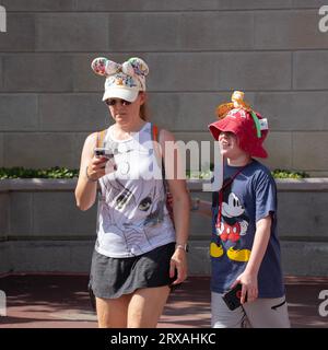 Orlando, USA - July 25th, 2023: Mother and son in a visit to Disney's Magic Kingdom, dressed accordingly. Stock Photo