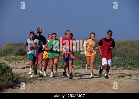 Young people jogging on the beach Stock Photo