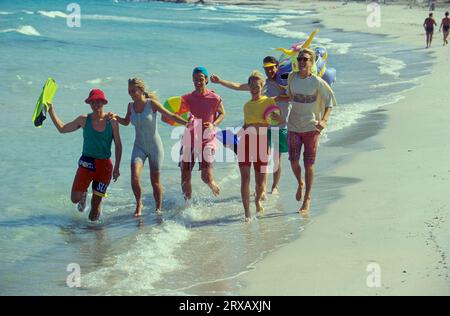 Young people on the sandy beach Stock Photo