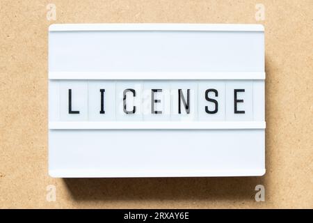Lightbox with word license on wood background Stock Photo