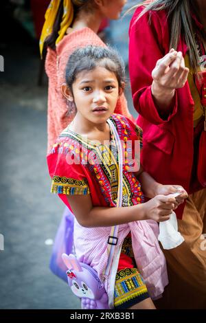 A pretty Thai girl shopping with her mother in Pratu Nam Market, Bangkok, Thailand. Stock Photo