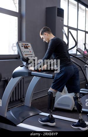 love of life. man concentrated on walking on treadmill, side view shot lifestyle hobby interest Stock Photo