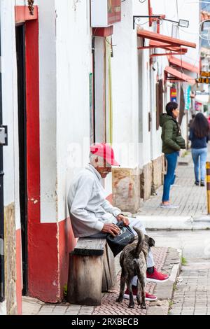 Tibasosa, Boyaca, Colombia - August 9th 2023. Senior man and his dog at the small town of Tibasosa located in the Boyaca department in Colombia Stock Photo
