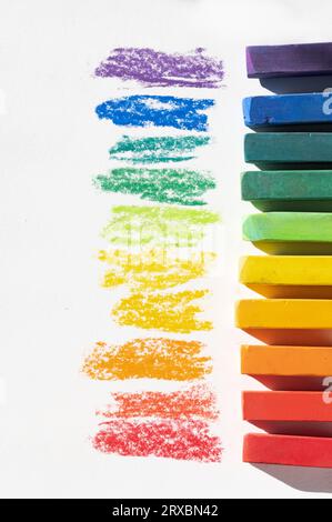 Dry Pastel Chalk in colors of rainbow on white background with text space to left Stock Photo