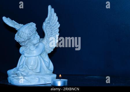 Photo of angel with copy space on dark background Stock Photo