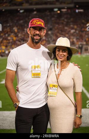 Michael Phelps and Nicole Phelps pose for a photo in the first quarter of an NCAA college football game against the Arizona State Sun Devils in Tempe, Stock Photo