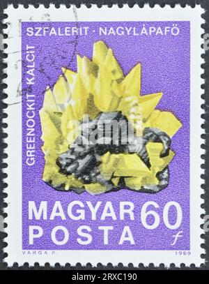 Cancelled postage stamp printed by Hungary, that shows Greenockit calcite sphalerite crystals, circa 1969. Stock Photo