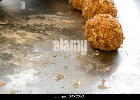The process of creating Scotch eggs has resulted in already-made Scotch eggs being placed on untidy surfaces. Stock Photo