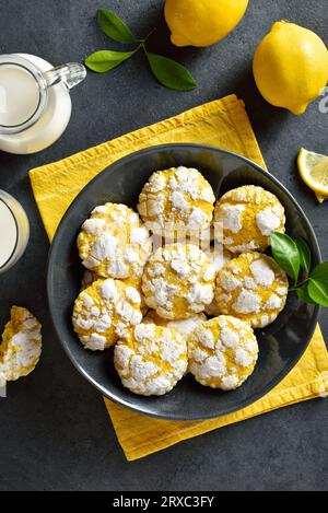 Lemon crinkle cookies on plate over blue stone background. Top view, flat lay Stock Photo