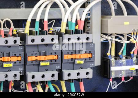 Close-up of Electricity distribution box with wires and circuit breakers in control room. Stock Photo
