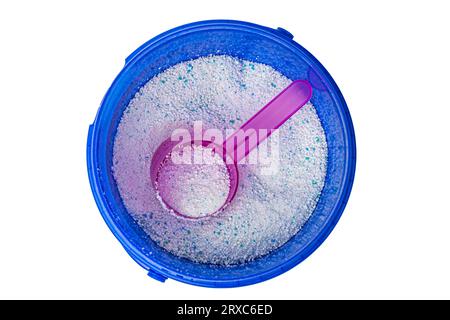 Washing powder in a plastic spoon in a blue plastic container, top view Stock Photo
