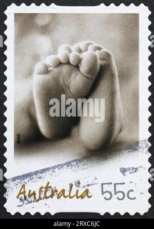 Human hand shaking a robotic hand on postage stamp Stock Photo