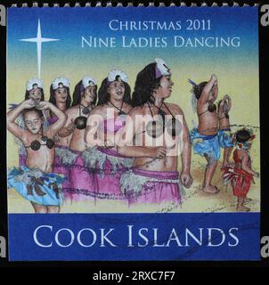 Twelve days of Christmas - 9 ladies dancing on postage stamp of Cook Islands Stock Photo