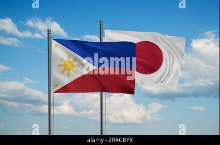 Japan flag and Philippines flag waving together on blue sky, two country cooperation concept Stock Photo