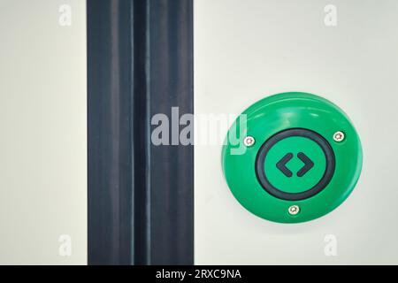 green emergency exit button to open door press here Stock Photo - Alamy