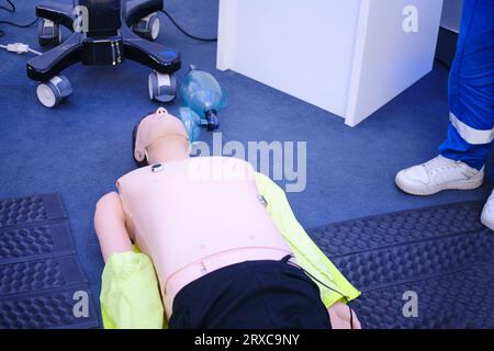 First aid training - CPR on a mannequin. Resuscitation to a training dummy in the emergency room Stock Photo
