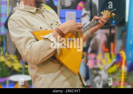 Man playing the balalaika in a music shop. Selective focus. Stock Photo