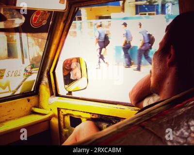 Cebu city, Philippines - October 03, 2013: Exhausted passenger man sleeping on a front seat of jeepney vehicle during traffic hour in Cebu city. Stock Photo