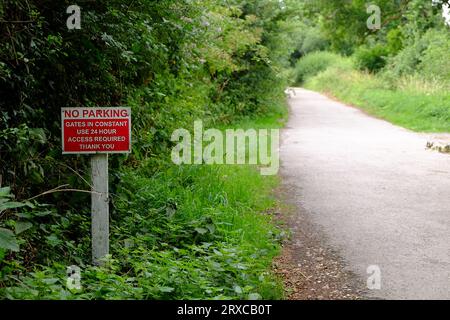 July 2023 - No Parking sign in a country lane to allow access through gates opposite. Stock Photo