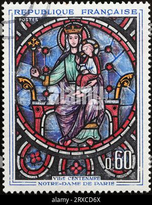 Ancient stained glass window from Notre Dame cathedral on stamp Stock Photo