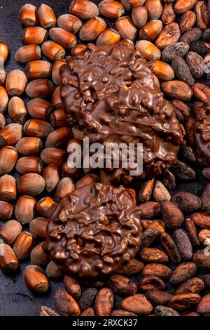Chocolate and hazelnut coated cookies on a wooden tray Stock Photo