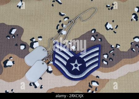 US AIR FORCE Staff Sergeant rank patch and dog tags on desert camouflage uniform background Stock Photo