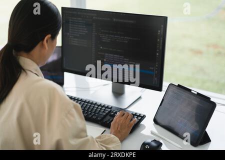 Developer programmer typing code on keyboard for programming to developing web and application. Stock Photo