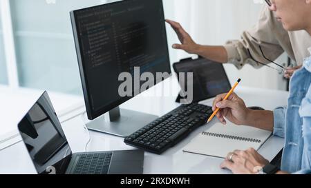 Two developer programmer checking code and writing note while programming to developing web and app. Stock Photo
