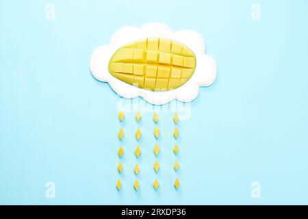 half fresh mango diced in classic cubes close-up isolated on blue background Stock Photo
